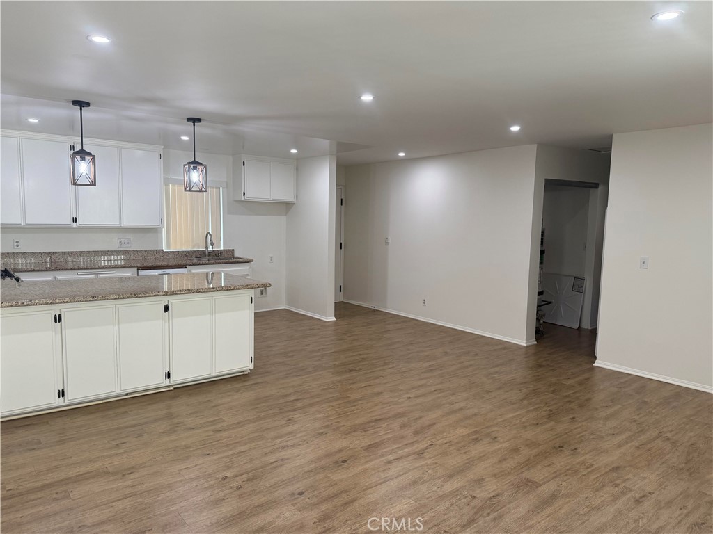 437 Richmond Street, Unit 4 El Segundo, CA 90245 - Photo 2 of 7 a large kitchen with stainless steel appliances a large counter top a sink and a refrigerator
