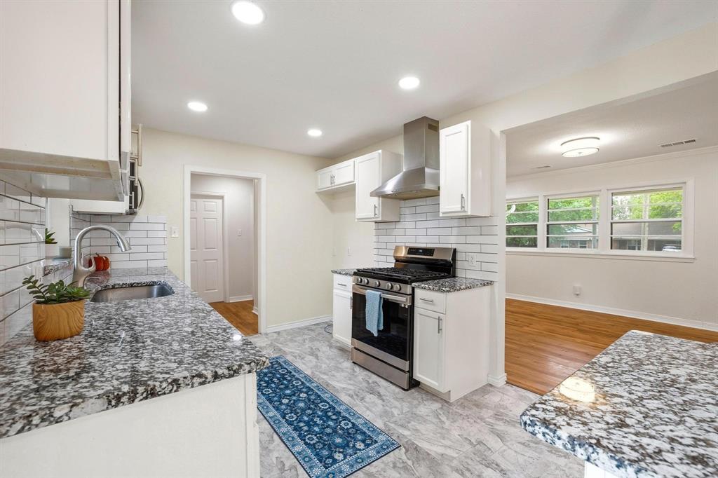 2401 Sunset Street Denison, TX 75020 - Photo 13 of 30 a kitchen with a stove a sink and a refrigerator