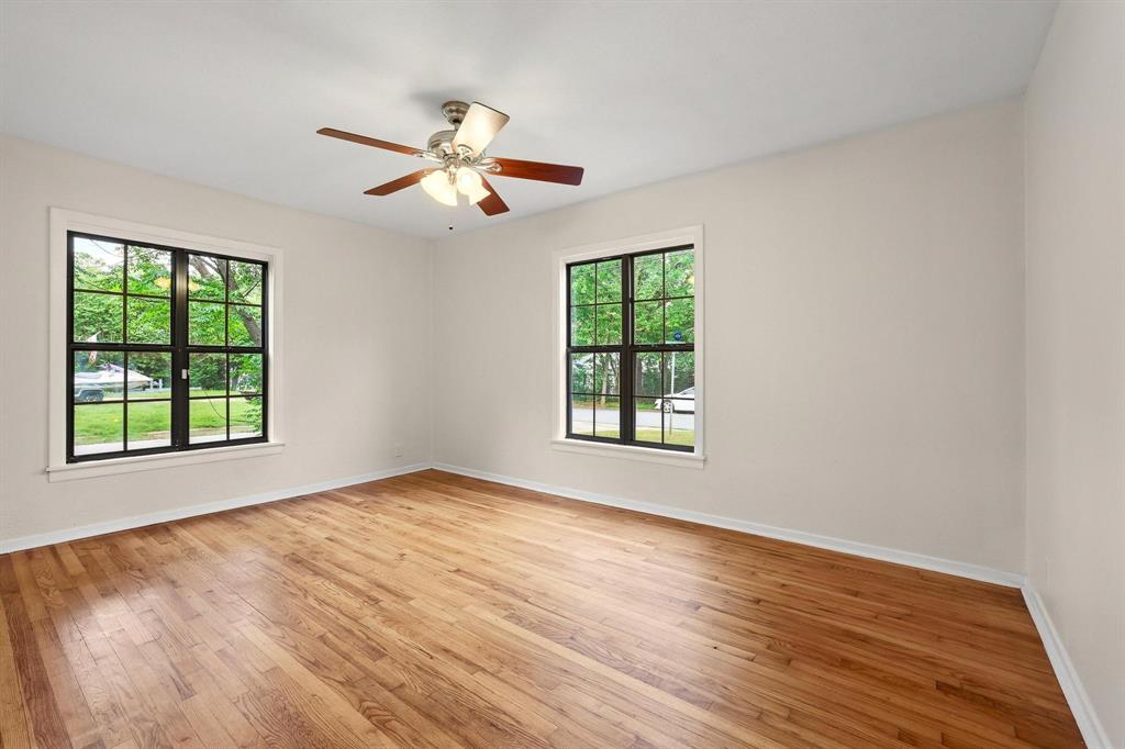2401 Sunset Street Denison, TX 75020 - Photo 18 of 30 an empty room with wooden floor fan and windows