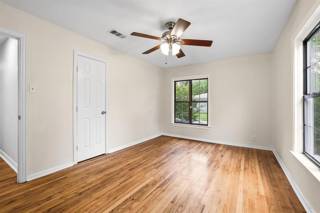 2401 Sunset Street Denison, TX 75020 - Photo 19 of 30 a view of empty room with wooden floor and fan