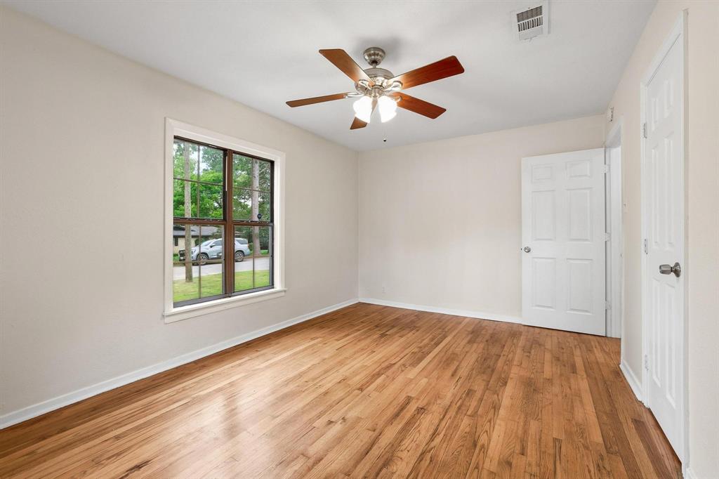 2401 Sunset Street Denison, TX 75020 - Photo 20 of 30 wooden floor in an empty room with a window