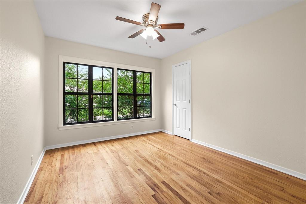 2401 Sunset Street Denison, TX 75020 - Photo 21 of 30 wooden floor in an empty room with a window