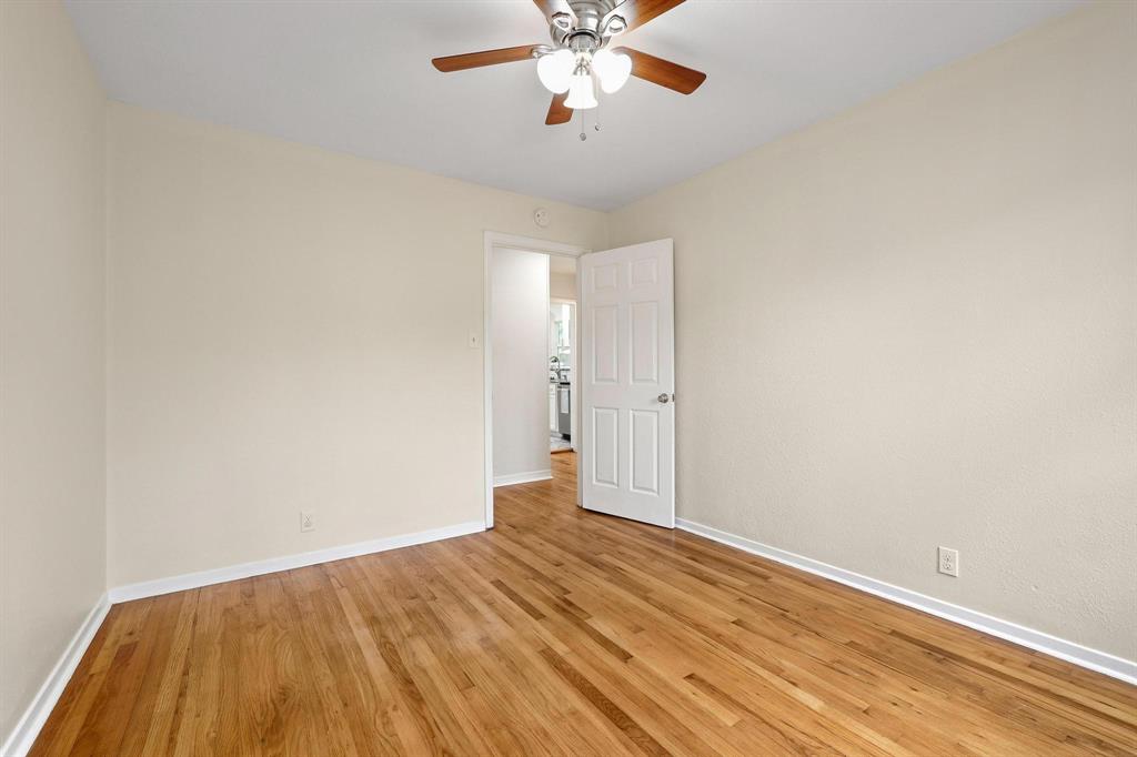 2401 Sunset Street Denison, TX 75020 - Photo 22 of 30 a view of a room with wooden floor and ceiling fan