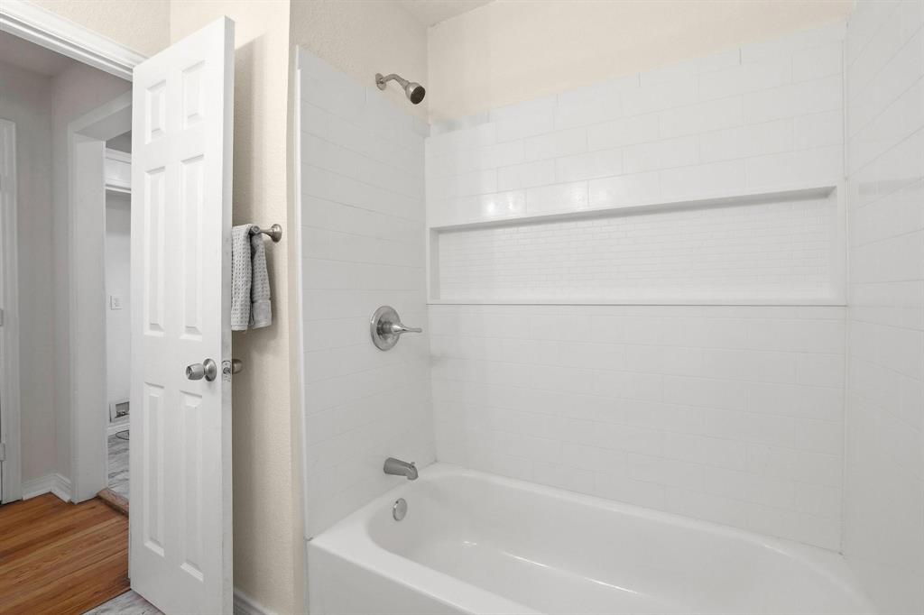 2401 Sunset Street Denison, TX 75020 - Photo 24 of 30 a bathroom with a bathtub