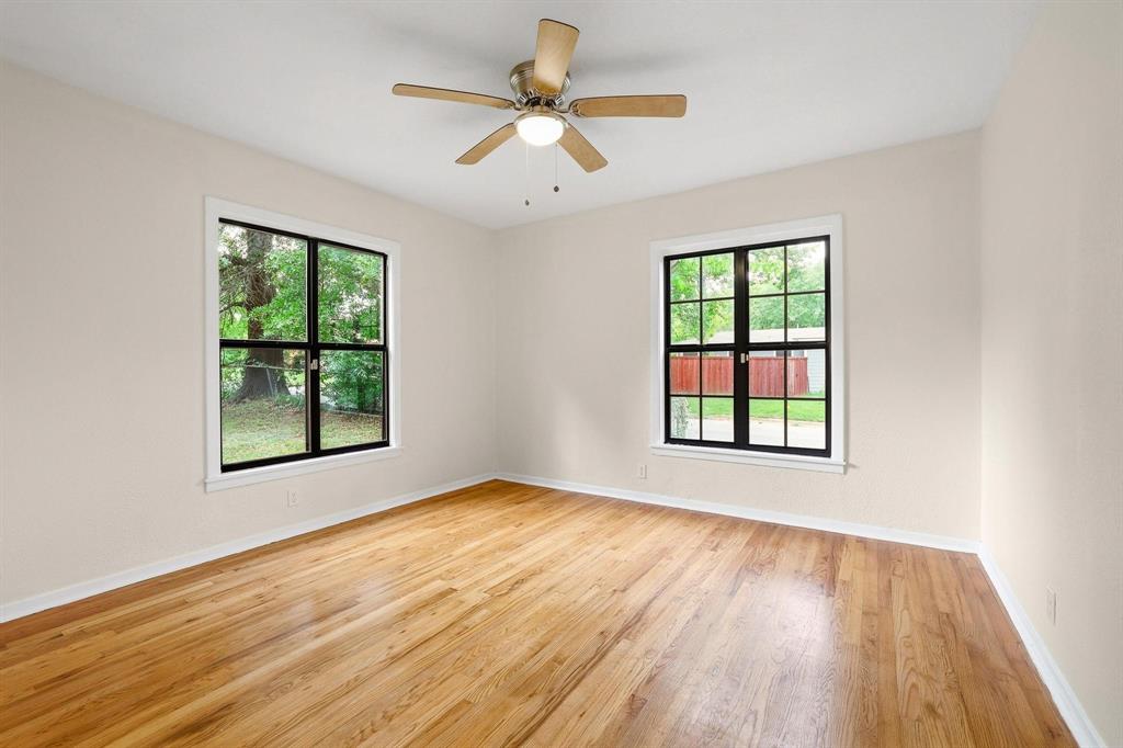2401 Sunset Street Denison, TX 75020 - Photo 25 of 30 a view of an empty room with wooden floor and a window