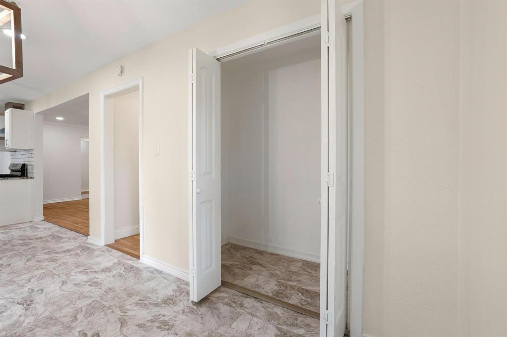 2401 Sunset Street Denison, TX 75020 - Photo 10 of 30 a view of a hallway with closet and wooden floor