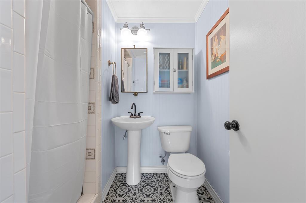 2216 Hermanson Drive Waco, TX 76710 - Photo 26 of 39 a bathroom with a toilet sink and mirror