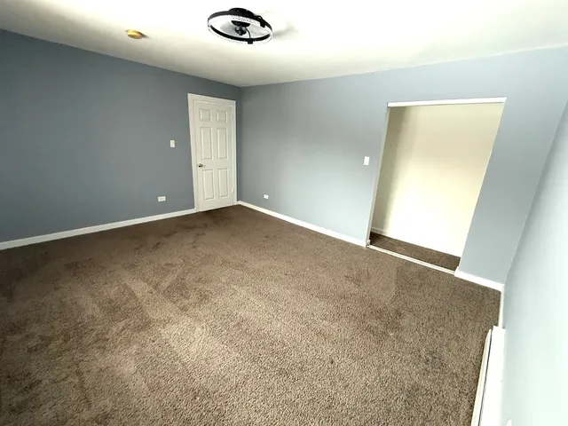 an empty room with a empty space and windows