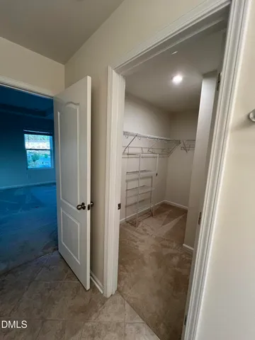 a bathroom with a toilet and a mirror