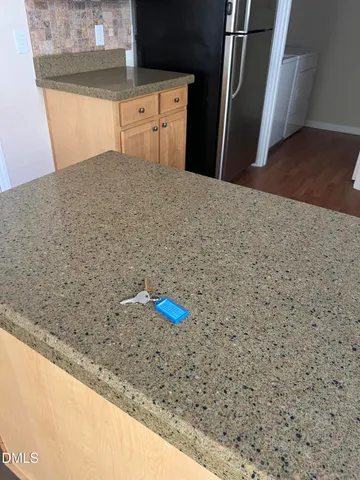 a view of n empty room with a ceiling fan and window