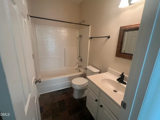 a large kitchen with stainless steel appliances granite countertop a stove a sink a refrigerator and a granite countertops with wooden floor