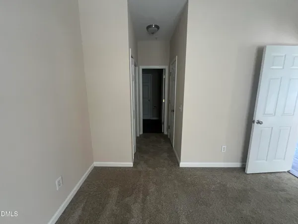 a view of a room with a ceiling fan
