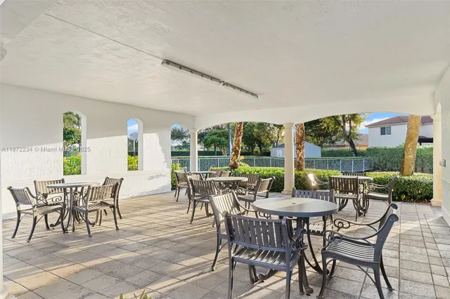 a view of a patio with chairs and table in patio