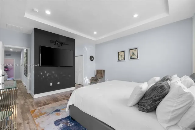 a bedroom with a double vanity sink and a mirror