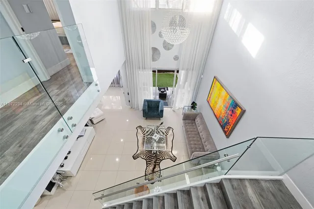 a room with lots of white furniture and mirror