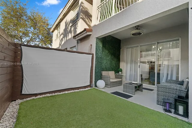 a backyard of a house with barbeque oven and a fountain