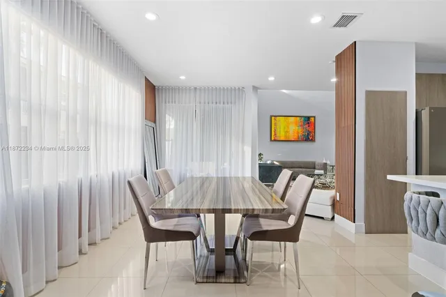 a view of a dining room with furniture and a chandelier