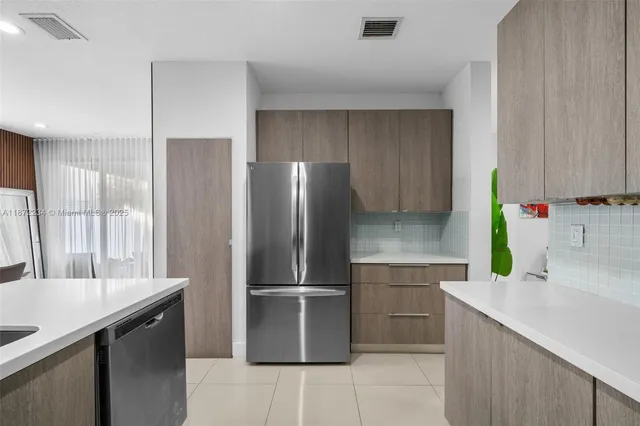 a kitchen with a refrigerator sink and stove
