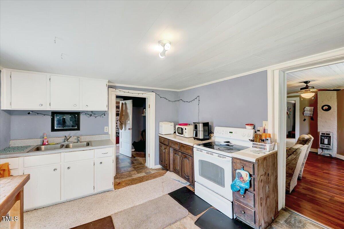 290 Collie Road Castalia, NC 27816 - Photo 28 of 61 a kitchen that has a lot of cabinets in it and wooden floors