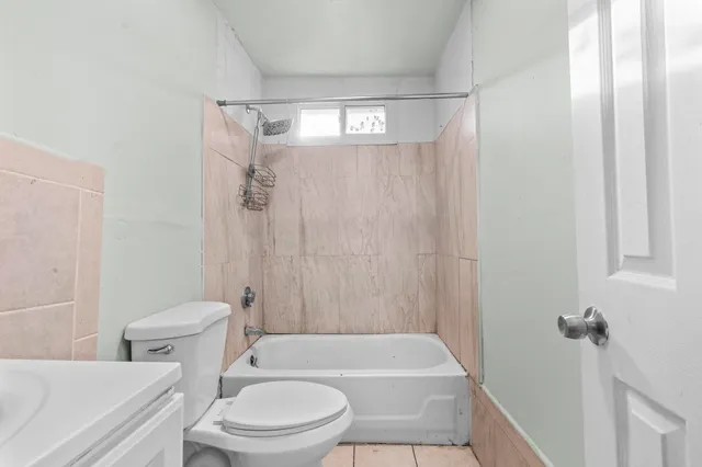 a bathroom with a toilet a sink and bathtub