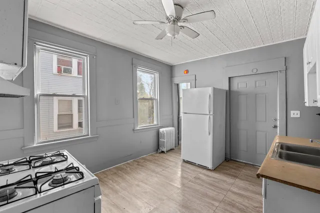 a kitchen with stainless steel appliances granite countertop a refrigerator stove sink and cabinets