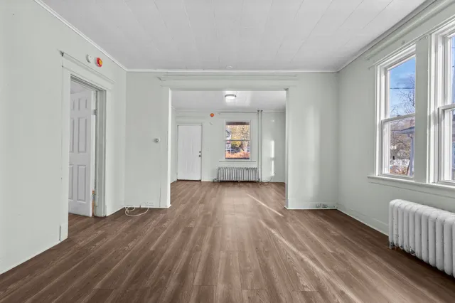 wooden floor in an empty room with a window