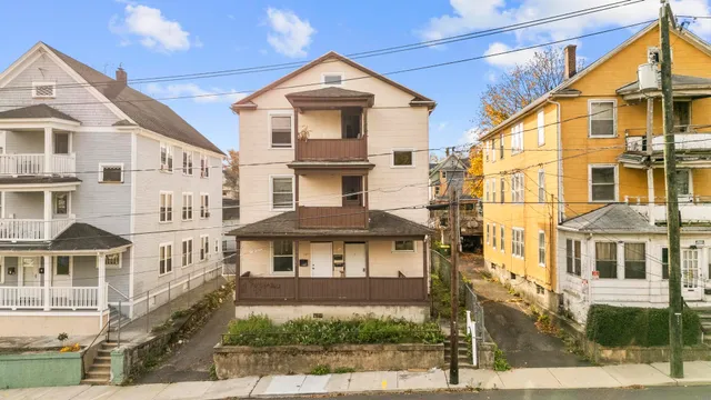 a front view of a residential apartment building with a yard