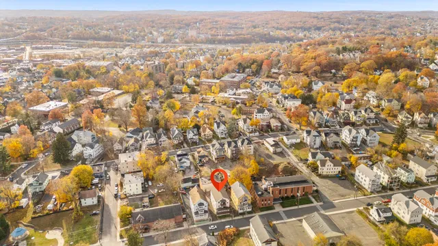 an aerial view of residential houses with city view