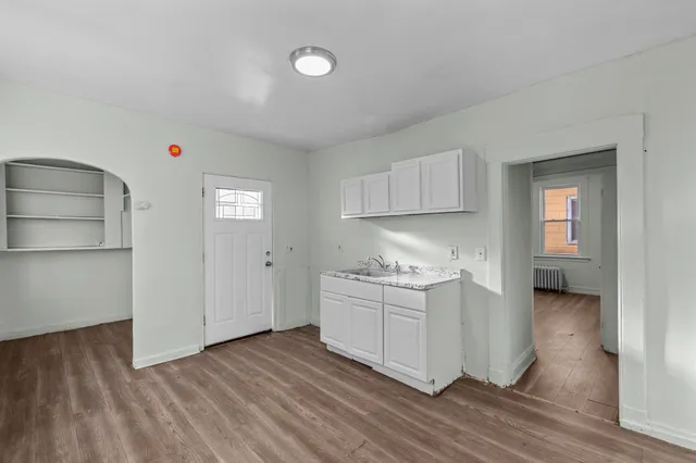 a room view with wooden floor and cabinet