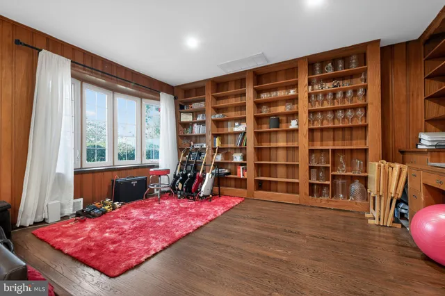 a living room with furniture and a bookshelf