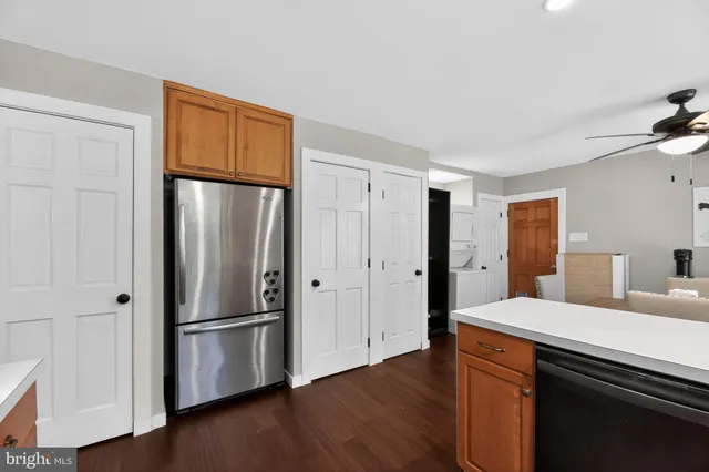 a kitchen with stainless steel appliances a refrigerator and wooden floor