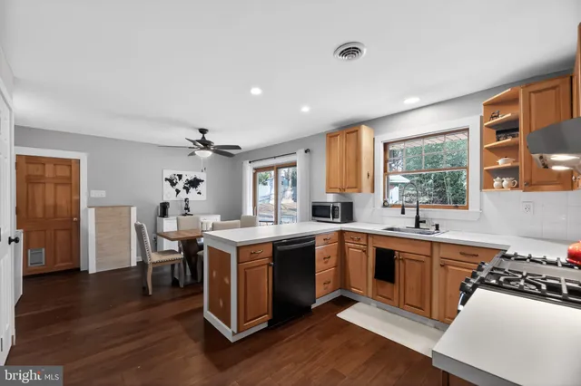 a kitchen with a sink stove and cabinets