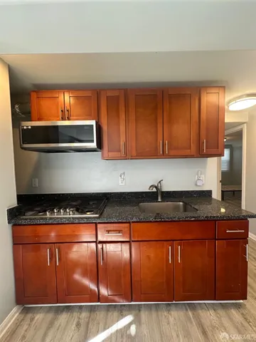 a kitchen with granite countertop cabinets and window