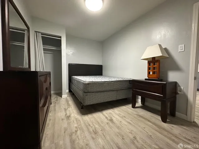 a bedroom with furniture and a lamp