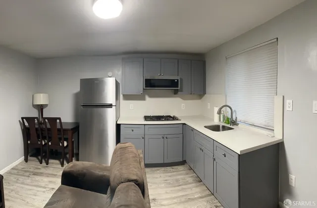 a kitchen with a sink dishwasher a refrigerator and a stove