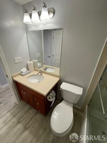 a bathroom with a toilet a sink and mirror