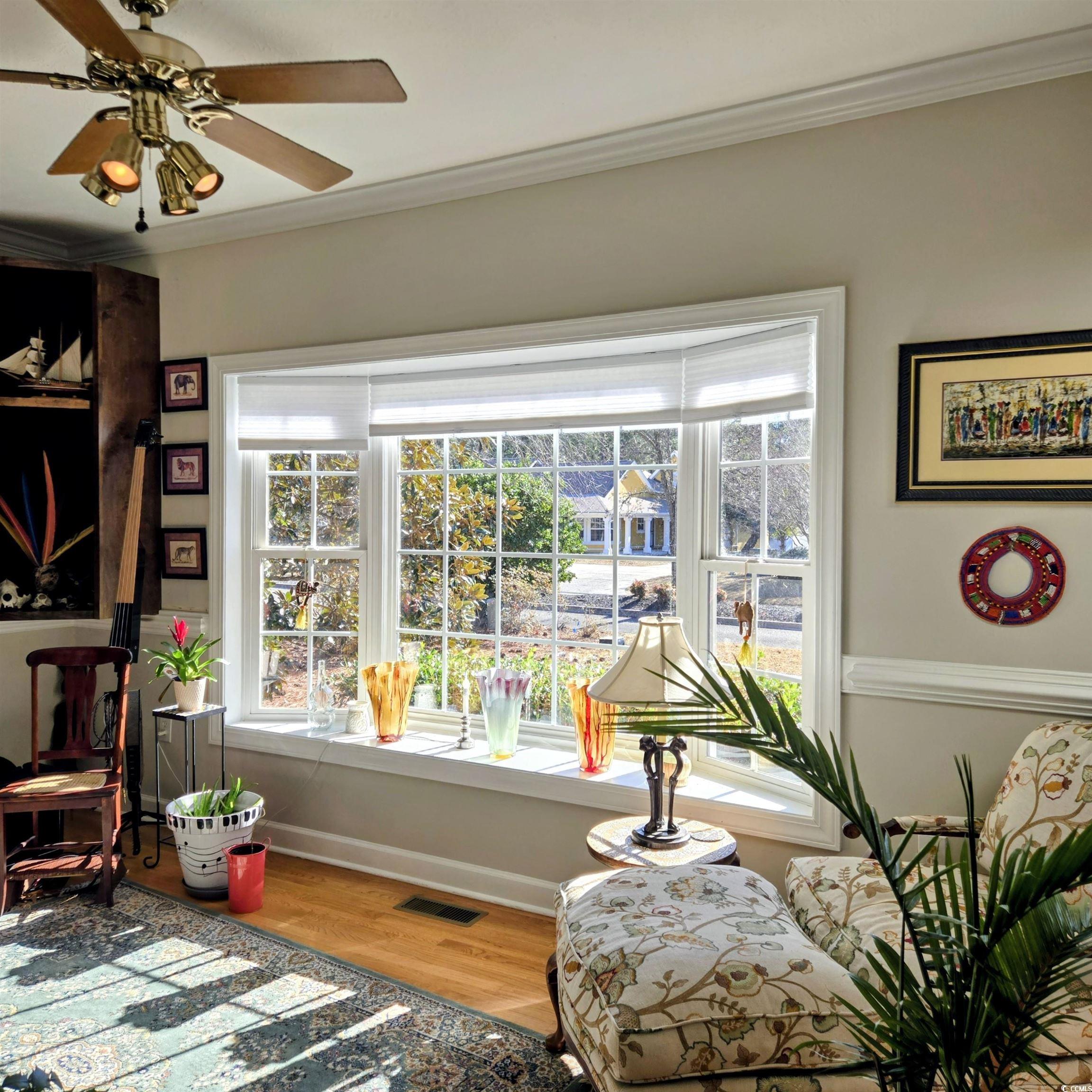 2410 Hunters Trail Myrtle Beach, SC 29588 - Photo 11 of 35 Living area featuring light wood-style floors, ornamental molding, and a ceiling fan