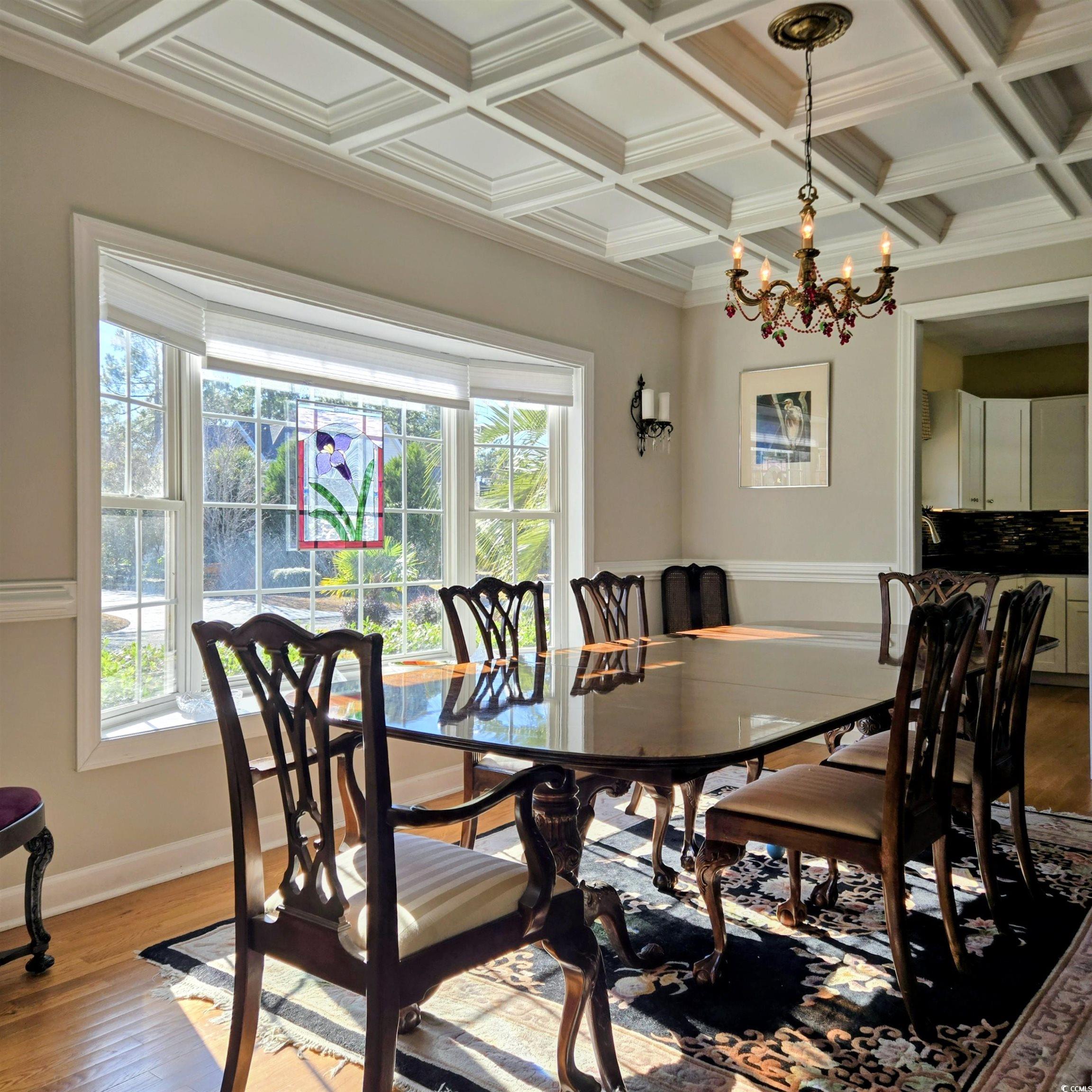 2410 Hunters Trail Myrtle Beach, SC 29588 - Photo 12 of 35 Dining area with wood-type flooring, ornamental molding, a chandelier, coffered ceiling, and beamed ceiling