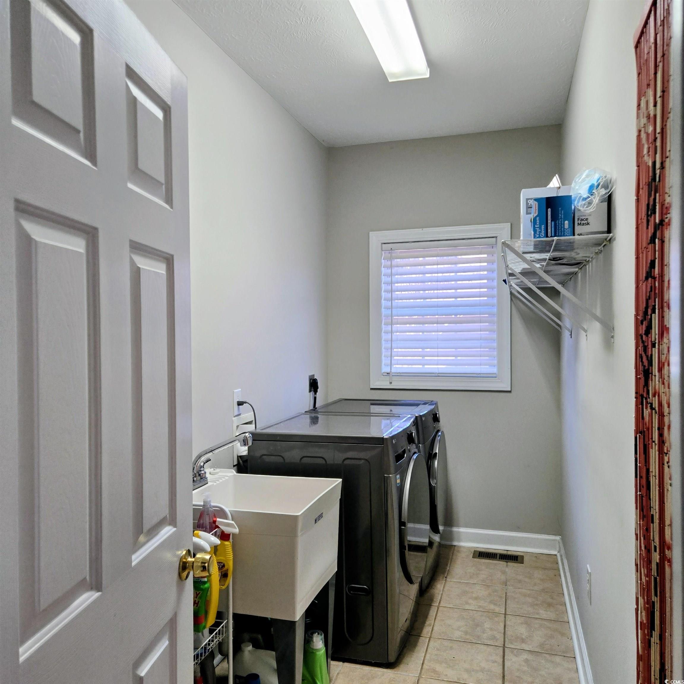 2410 Hunters Trail Myrtle Beach, SC 29588 - Photo 15 of 35 Laundry area featuring light tile patterned flooring and independent washer and dryer