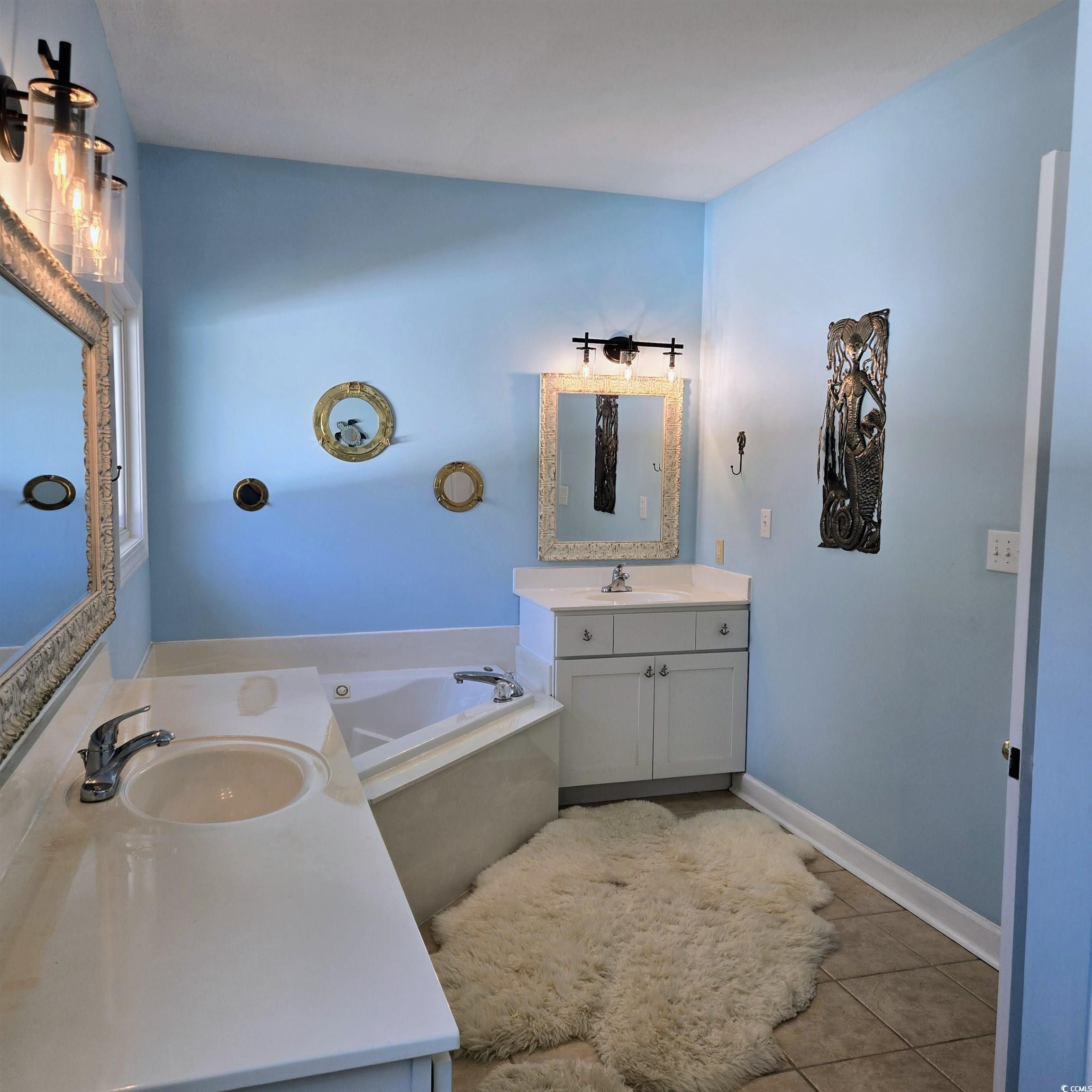 2410 Hunters Trail Myrtle Beach, SC 29588 - Photo 19 of 35 Bathroom featuring two vanities, a bath, and light tile patterned flooring
