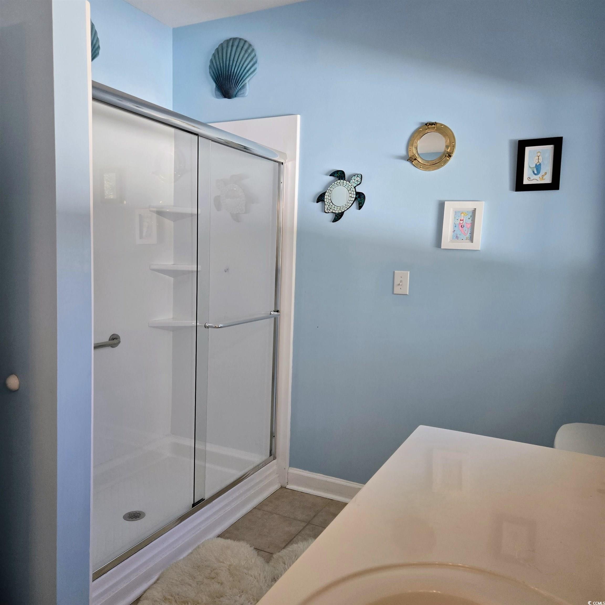 2410 Hunters Trail Myrtle Beach, SC 29588 - Photo 20 of 35 Bathroom with a stall shower, vanity, and light tile patterned floors