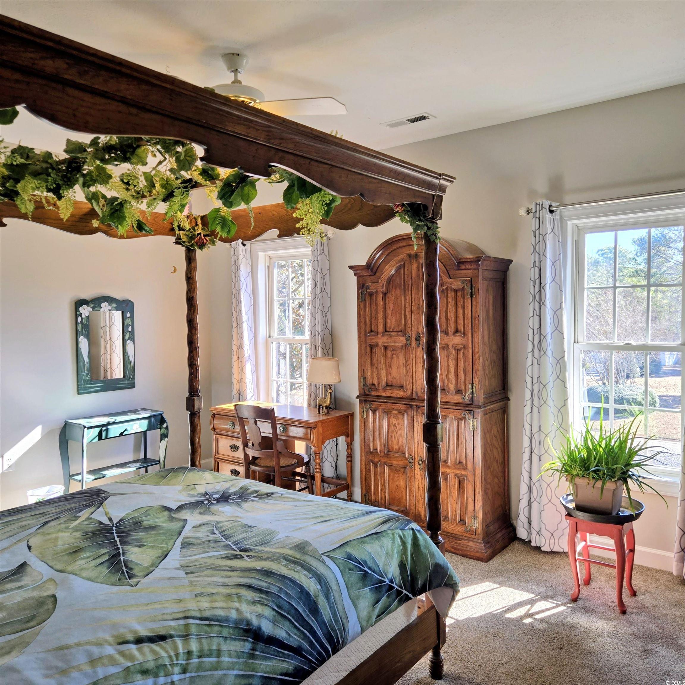 2410 Hunters Trail Myrtle Beach, SC 29588 - Photo 21 of 35 Carpeted bedroom with multiple windows and a ceiling fan