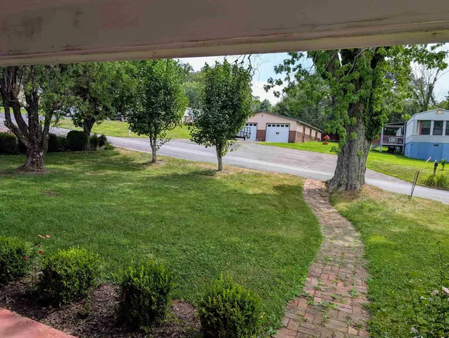 a view of a dining room with furniture wooden floor and chandelier