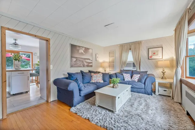 a living room with furniture or couch and a wooden floor