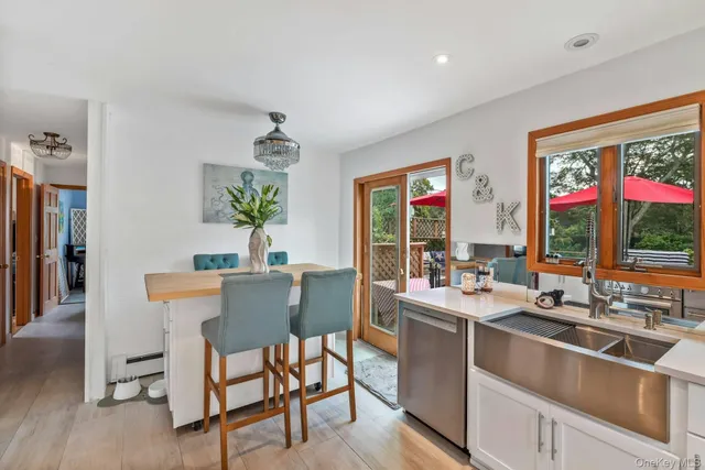 a room with a table chairs and entryway
