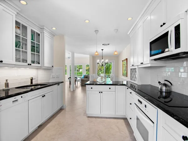 a kitchen with granite countertop a sink and cabinets