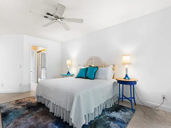 a bedroom with a bed and a lamp