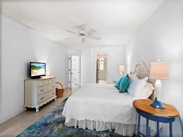 a bedroom with a bed and a lamp on table