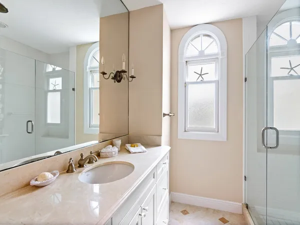 a bathroom with a double vanity sink and a mirror
