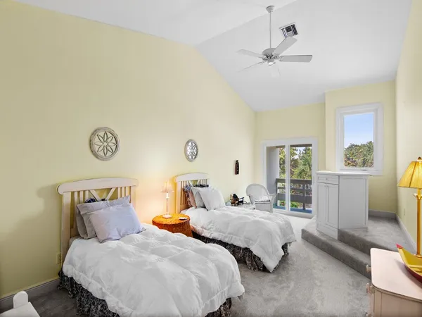 a bedroom with two beds and a window